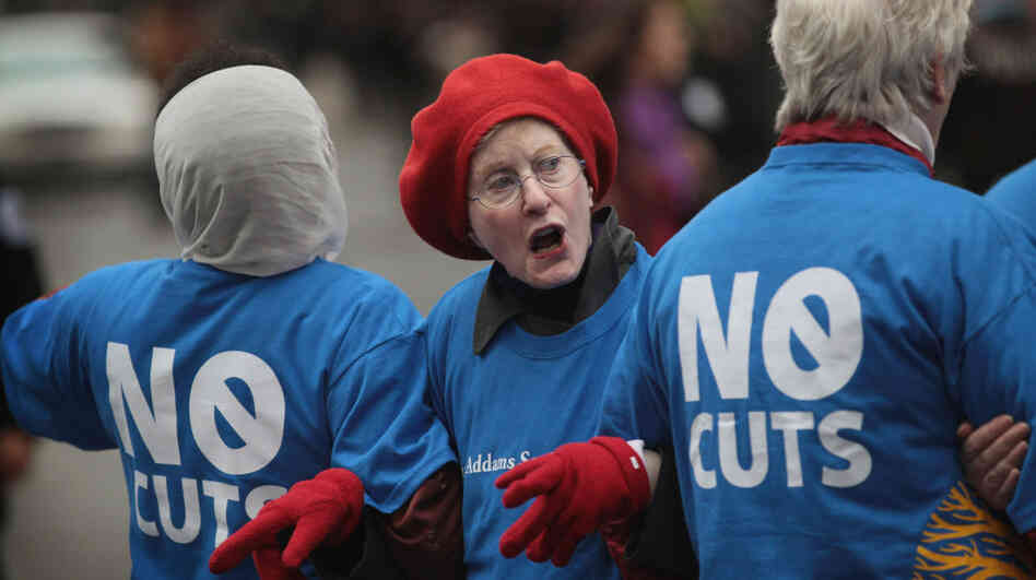 Judy Moses, 71, prepares to be arrested during an Occupy Chicago protest against cuts to federal safety net programs, including Social Security, Medicare and Medicaid, on Monday.