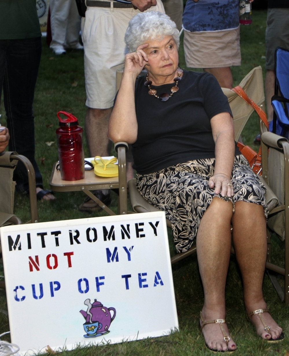 In this Sept. 4 file photo, Ann Kalifrath listens to Republican presidential candidate and former Massachusetts Gov. Mitt Romney speak at a Tea Party Express rally in Concord, N.H.