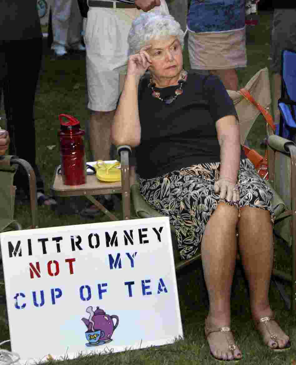 In this Sept. 4 file photo, Ann Kalifrath listens to Republican presidential candidate and former Massachusetts Gov. Mitt Romney speak at a Tea Party Express rally in Concord, N.H.