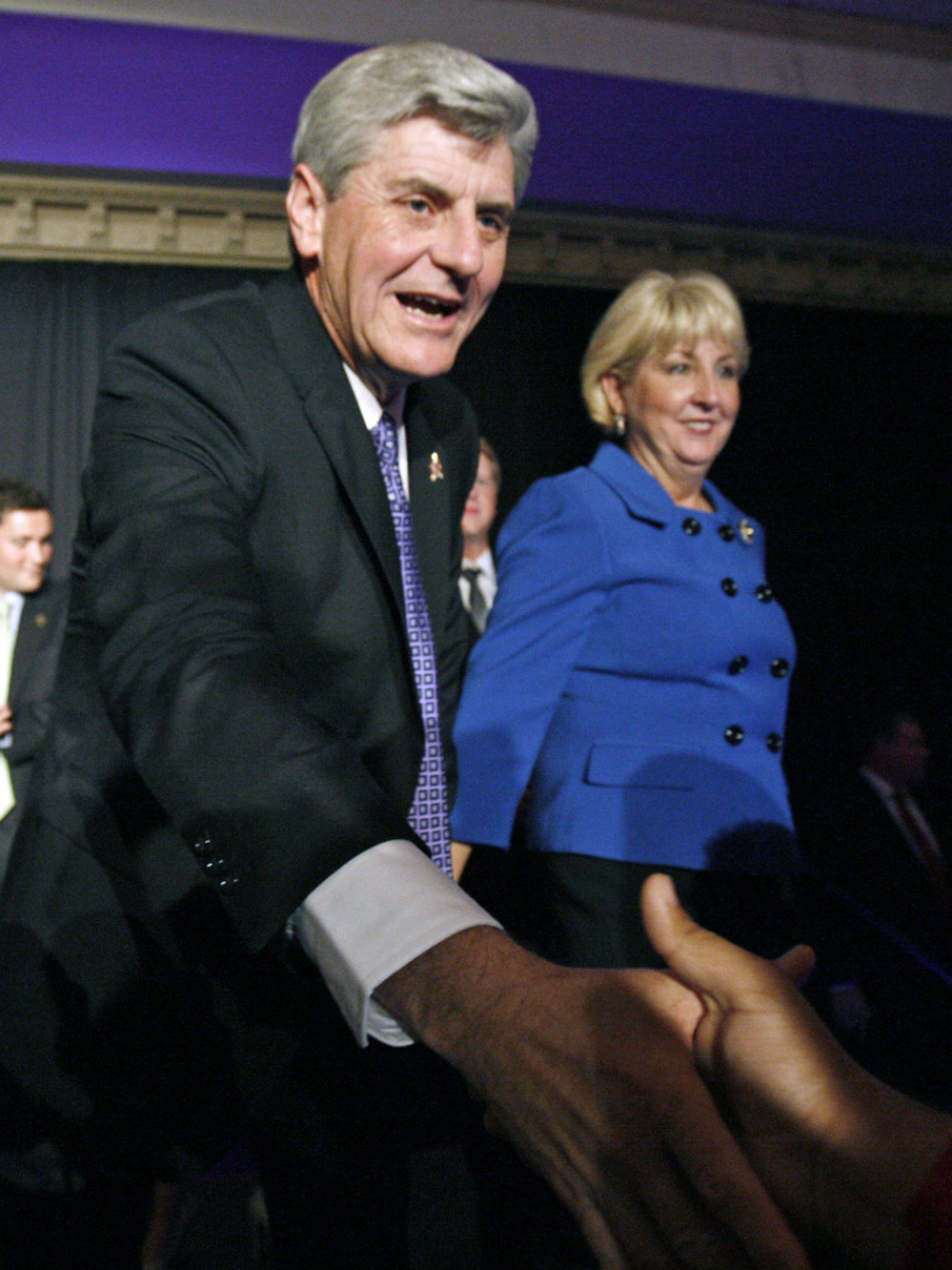 Wife Deborah Bryant waits as Mississippi Governor-elect Phil Bryant thanks a supporter Tuesday at a victory party. Bryant supported a controversial amendment to the state's constitution on "personhood."