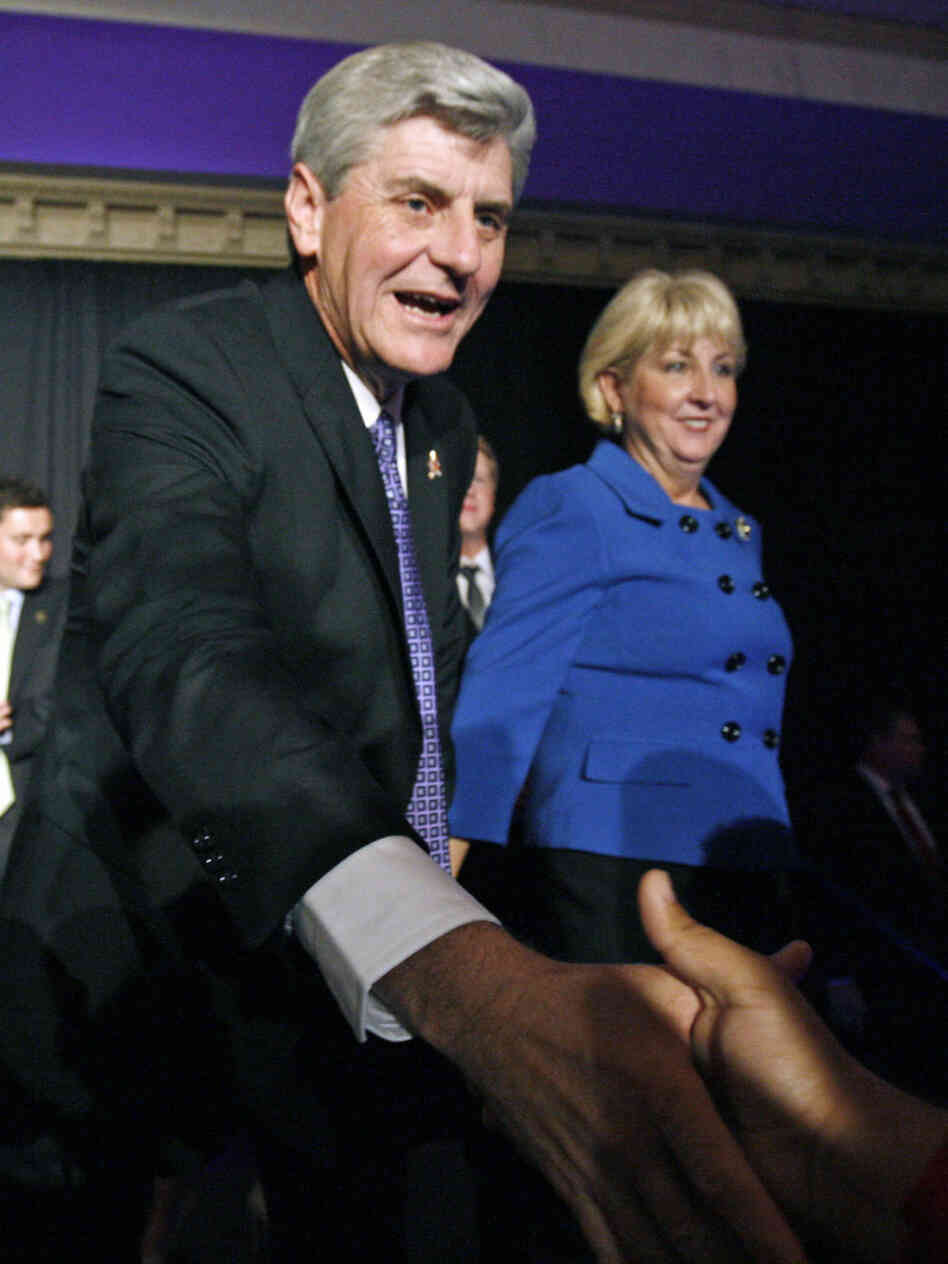 Wife Deborah Bryant waits as Mississippi Governor-elect Phil Bryant thanks a supporter Tuesday at a victory party. Bryant supported a controversial amendment to the state's constitution on "personhood."