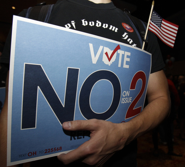 A supporter of the initiative to repeal an anti-union bill holds his sign in Columbus, OH, Nov. 8, 2011,