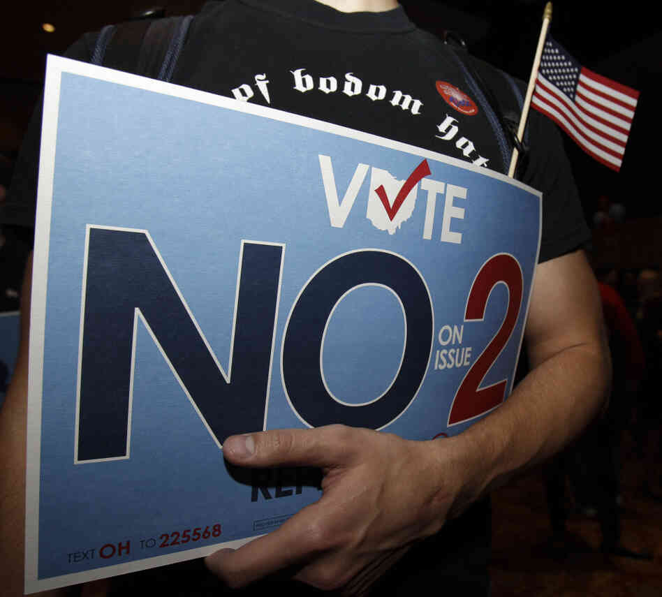 A supporter of the initiative to repeal an anti-union bill holds his sign in Columbus, OH, Nov. 8, 2011,