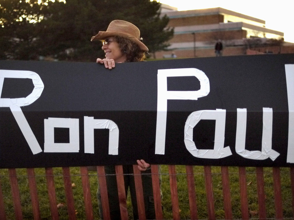 Sue McQueen displays her support for GOP presidential candidate Rep. Ron Paul outside the debate venue, Rochester, Mich., Nov. 9, 2011.