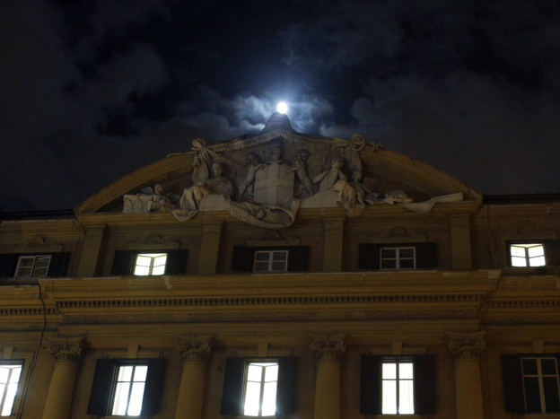 The moon rose above Italy's finance and economy ministry in Rome on Monday. 