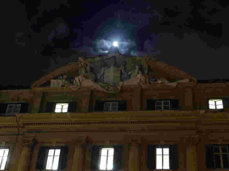 The moon rose above Italy's finance and economy ministry in Rome on Monday. 