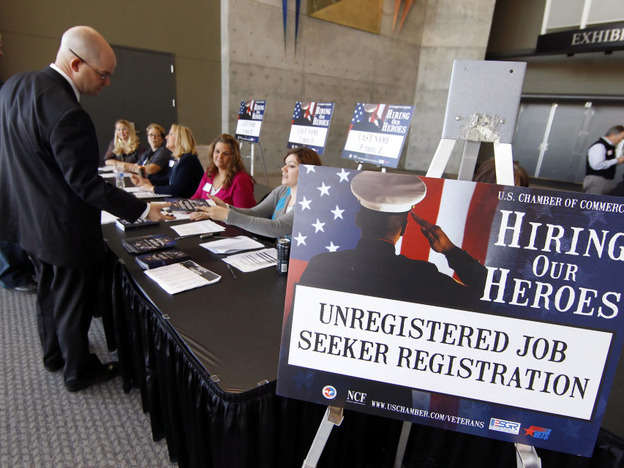 Veterans register for the "Hiring Our Heroes" job fair on Nov. 4 at the South Towne Expo Center in Sandy, Utah. Some 240,000 veterans who served in Iraq and Afghanistan are out of work.