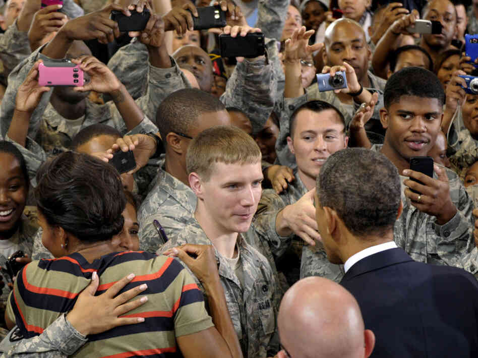 President Obama and first lady Michelle Obama meet troops during a stop at Joint Base Langley-Eustis in Hampton, Va, on Oct. 19. Obama says service members who fought for their country shouldn't have to fight for jobs when they come home. 