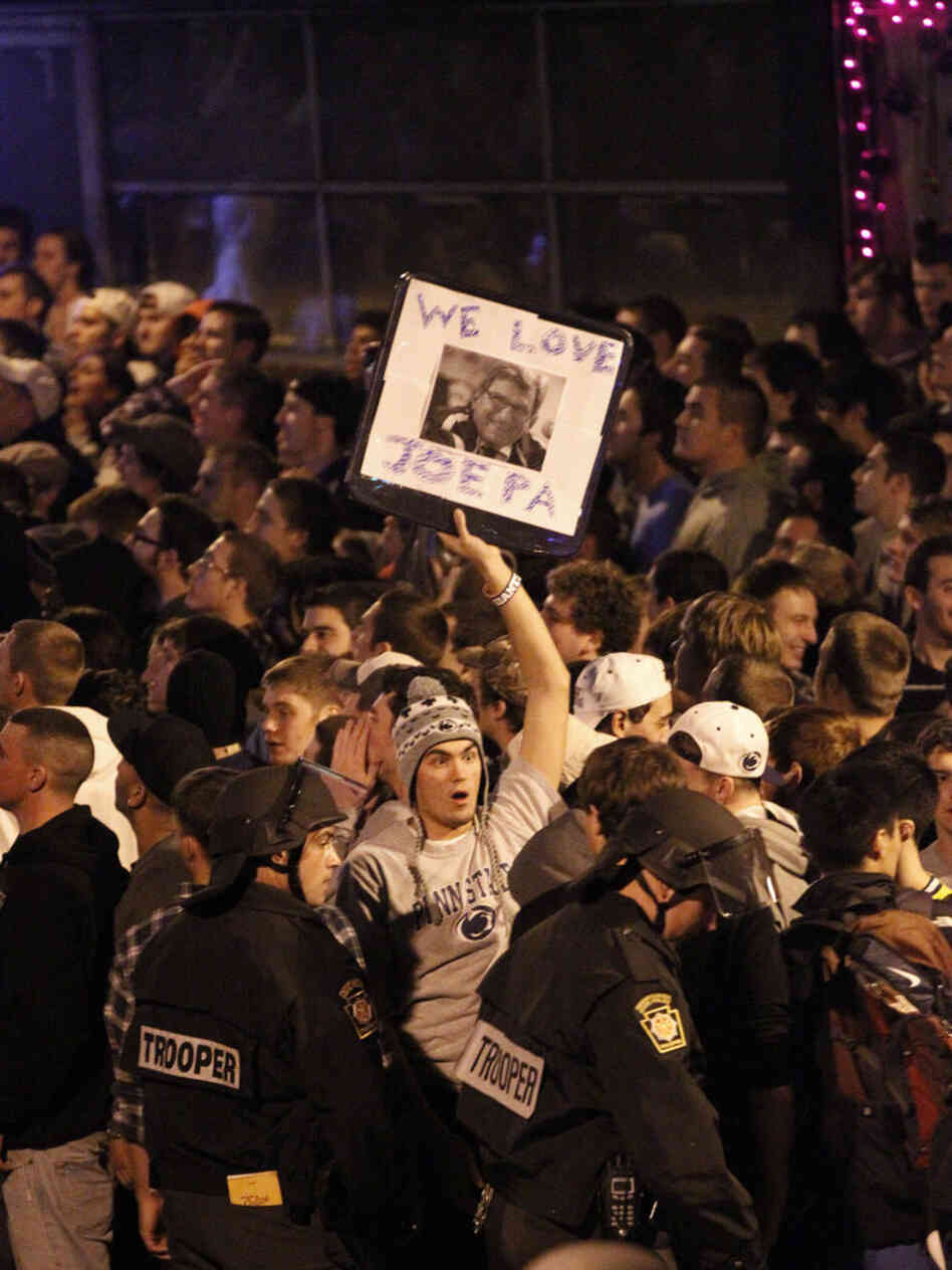 Scores of students gathered late Wednesday near the Penn State campus in State College, Pa., to protest the firing of football coach Joe Paterno. Dozens of police officers wearing helmets and carrying pepper spray were called in to control the crowd.