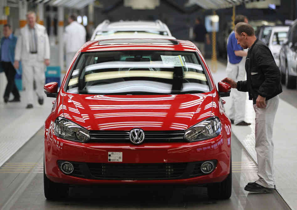 Workers prepare new Volkswagen Golf cars at a factory in Wolfsburg, Germany. Workers prepare new Volkswagen Golf cars at a factory in Wolfsburg, Germany.