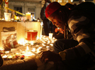 An Occupy Oakland demonstrator lights a candle after a man was shot and killed near the Occupy Oakland camp. An Occupy Oakland demonstrator lights a candle after a man was shot and killed near the Occupy Oakland camp.