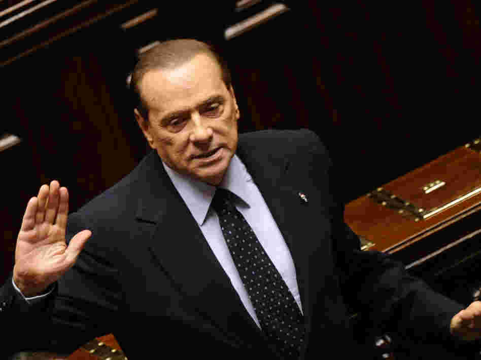 Italian Prime Minister Silvio Berlusconi acknowledges applause before leaving parliament's lower chamber in Rome on Saturday. Berlusconi resigned after the lower chamber passed an austerity package. 