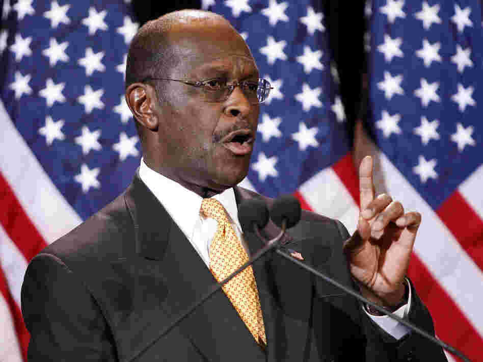 Republican presidential candidate Herman Cain addresses the media on Tuesday in Arizona. Cain said he would not drop his bid for the Republicans' presidential nomination in the face of decade-old allegations of inappropriate sexual behavior.