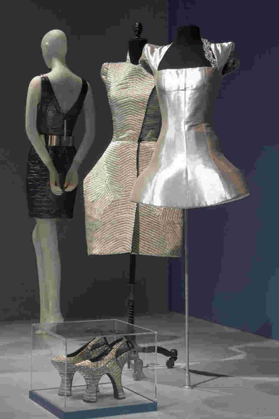 Guinness' metallic couture dresses evoke armor and echo her trademark platinum-and-black hair. Guinness' style has inspired many couture designers, but, according to the Museum at FIT, she insists she is no muse — instead she describes herself as a "bee" flitting from one designer to the next.
