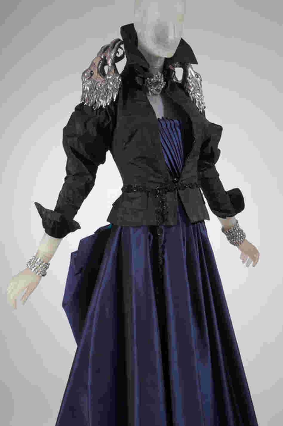 In this ensemble, Guinness pairs a dress by French-born designer Christian Lacroix with an eagle jacket by the late British designer Alexander McQueen. The jacket was a gift from McQueen who was a close friend of Guinness'.