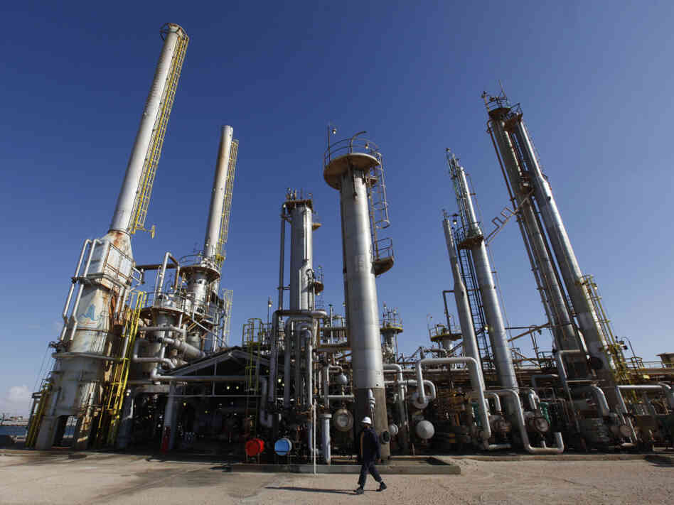 A worker walks in front of a refinery inside the Brega oil complex in Libya. 