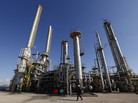 A worker walks in front of a refinery inside the Brega oil complex in Libya. A worker walks in front of a refinery inside the Brega oil complex in Libya.