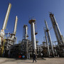 A worker walks in front of a refinery inside the Brega oil complex in Libya. A worker walks in front of a refinery inside the Brega oil complex in Libya.