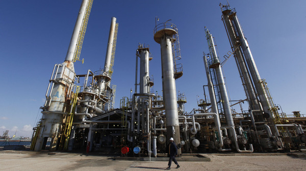 A worker walks in front of a refinery inside the Brega oil complex in Libya.
