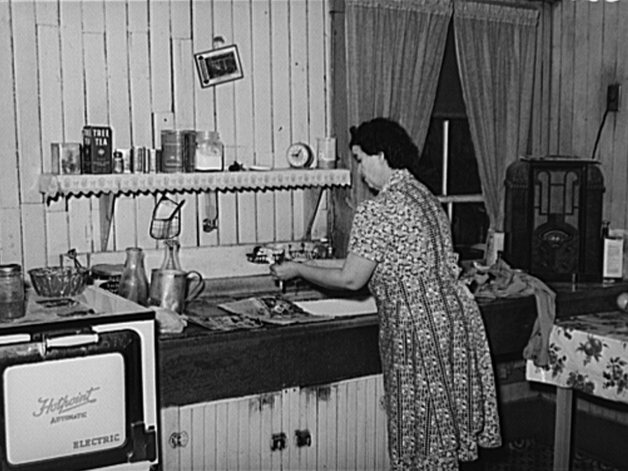 Woman washing dishes while listening to the radio.