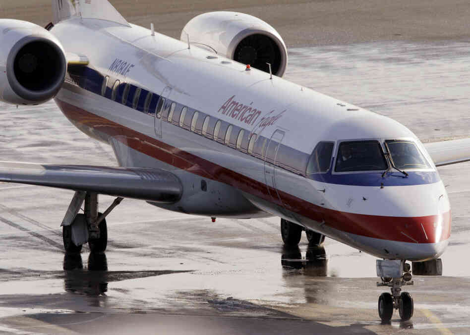 In this January 2011 file photo, an American Eagle jet taxis at Boston's Logan International Airport. 