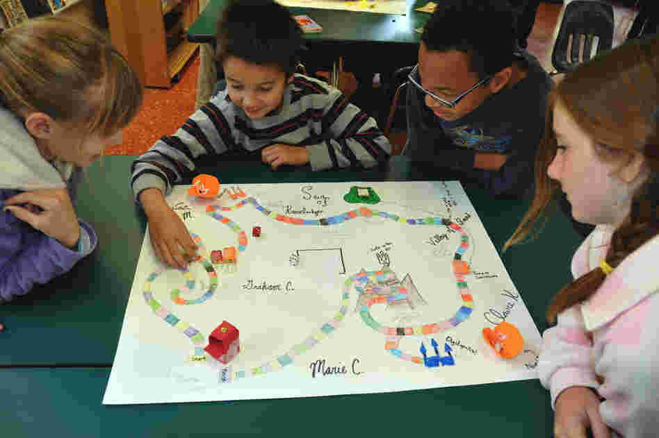 Fifth graders at The UCLA Lab School play a board game they created inspired by The Phantom Tollbooth. From left: Marie Chorpita, Graham Campbell, Ryan Martin and Claire Kaplan.