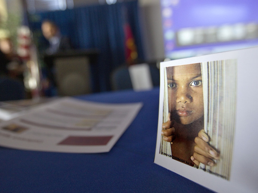 A placard featuring the photo of a child sits on a table during a conference on human sex trafficking last month in Atlanta. In Fairfax County, Va., gang members who have forced girls as young as 12 into prostitution are being sent to prison. Prosecutors there expect to bring more sex trafficking cases against gang members over the next several months.