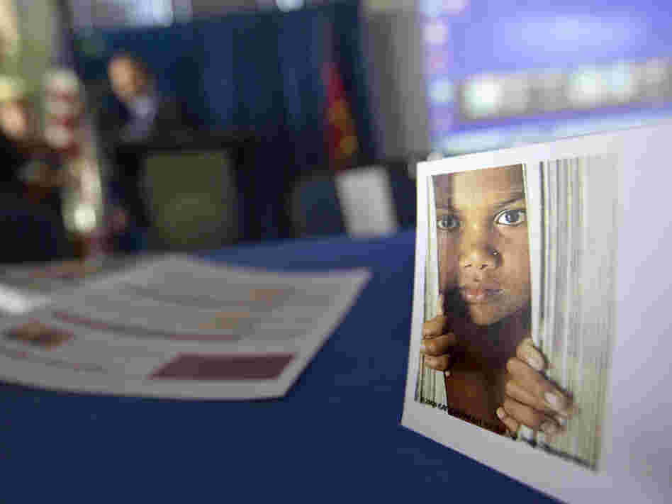A placard featuring the photo of a child sits on a table during a conference on human sex trafficking last month in Atlanta. In Fairfax County, Va., gang members who have forced girls as young as 12 into prostitution are being sent to prison. Prosecutors there expect to bring more sex trafficking cases against gang members over the next several months.