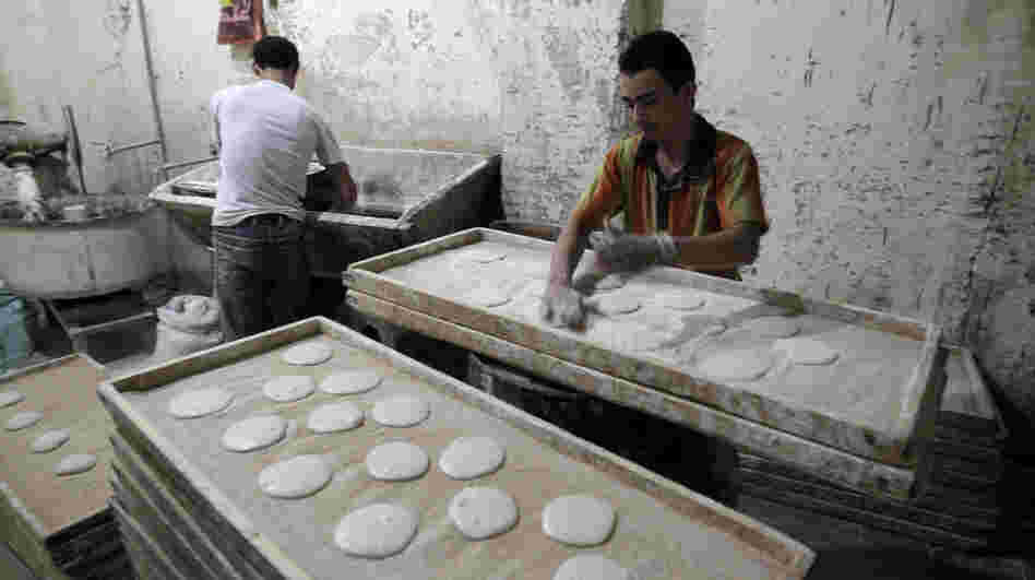 Egyptians are seen working in a bakery in Cairo. The U.S. has been working on ways to help revive the economies of nations in transition, like Egypt, Tunisia and Libya, while having limited resources available during tough economic times.