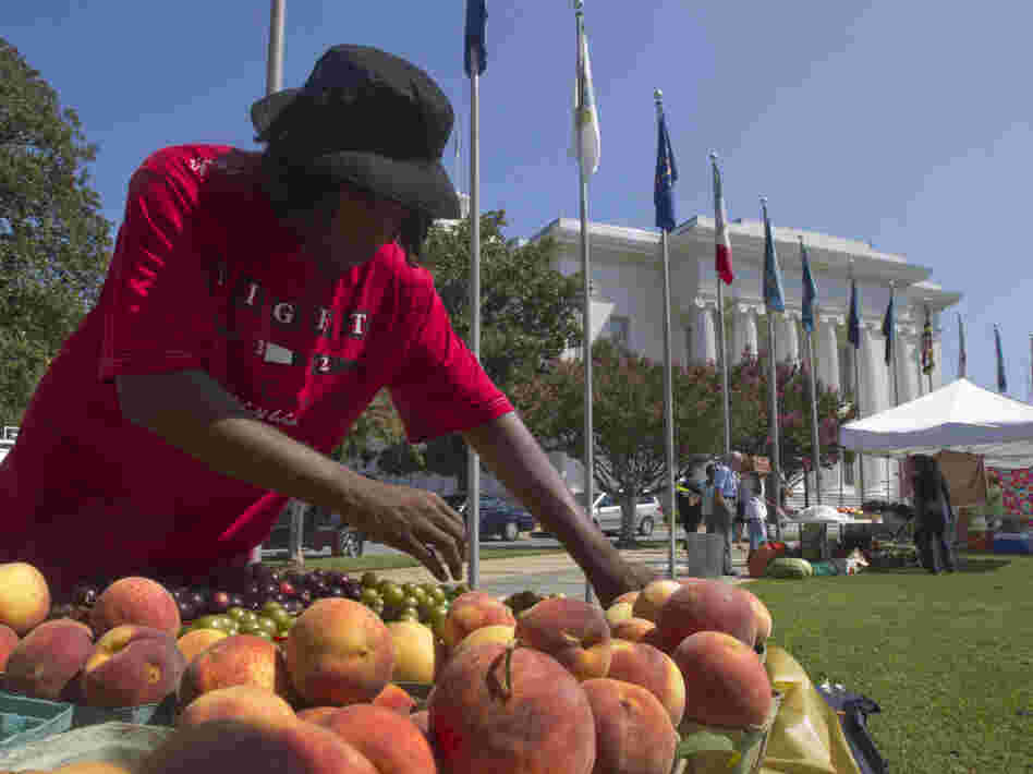 Desmond Brown sells fruits and vegetables at a farmer's market outside the Alabama Capitol in Montgomery, Ala.