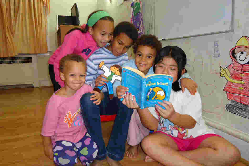From left: Carina Jaffe, 3; Larissa Jaffe, 9; Denali Jaffe, 10; Zahra Jaffe, 6; and their friend Christina Tonnu, 8, read The Phantom Tollbooth together in Philadelphia.