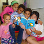 Carina Jaffe, 3; Larissa Jaffe, 9; Denali Jaffe, 10; Zahra Jaffe, 6; and their friend Christina Tonnu, 8, read The Phantom Tollbooth together in Philadelphia.