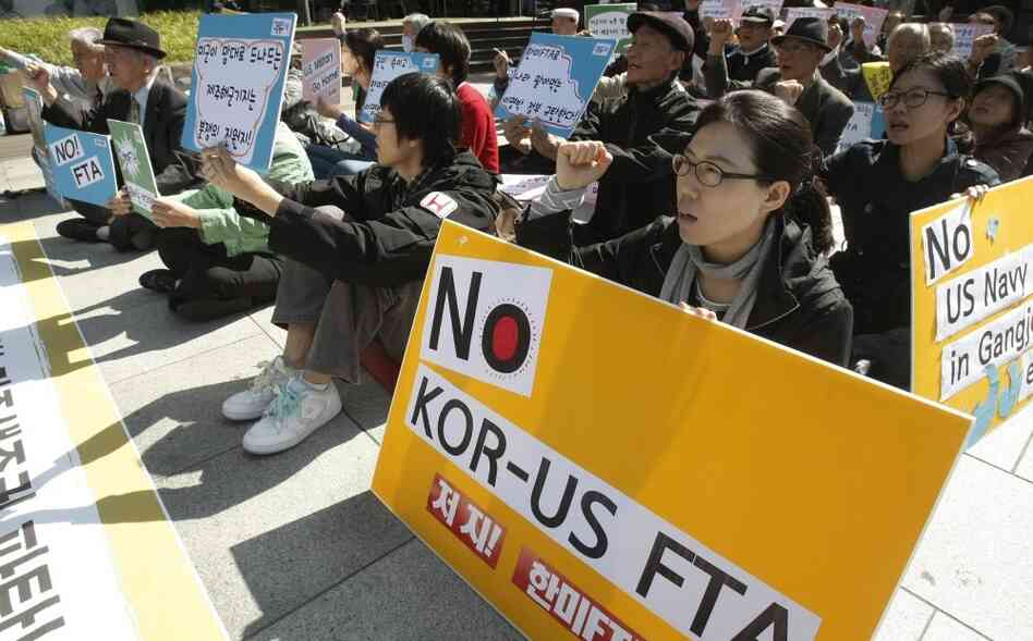 South Korean protesters shout slogans during a rally against a free trade agreement between South Korea and the United States near the U.S. Embassy in Seoul, South Korea, Oct. 11.