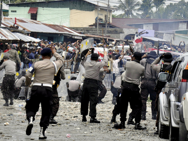 Police clash with workers of American mining company Freeport-McMoRan during a protest in Timika, Papua province, Indonesia, Oct. 10. Indonesian security forces fired on striking workers at Freeport-McMoRan's Grasberg gold and copper mine after a protest turned deadly.