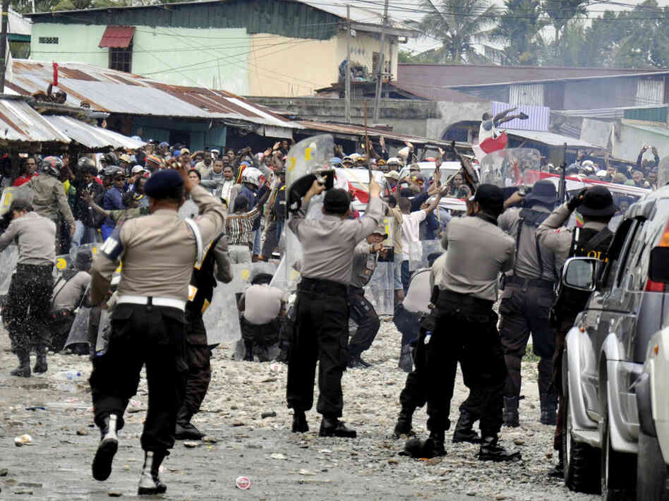 Police clash with workers of American mining company Freeport-McMoRan during a protest in Timika, Papua province, Indonesia, Oct. 10. Indonesian security forces fired on striking workers at Freeport-McMoRan's Grasberg gold and copper mine after a protest turned deadly.