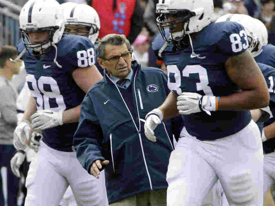 Then-Penn State head coach Joe Paterno gets out of the way during warm-ups before an NCAA college football game in State College, Pa., last month.