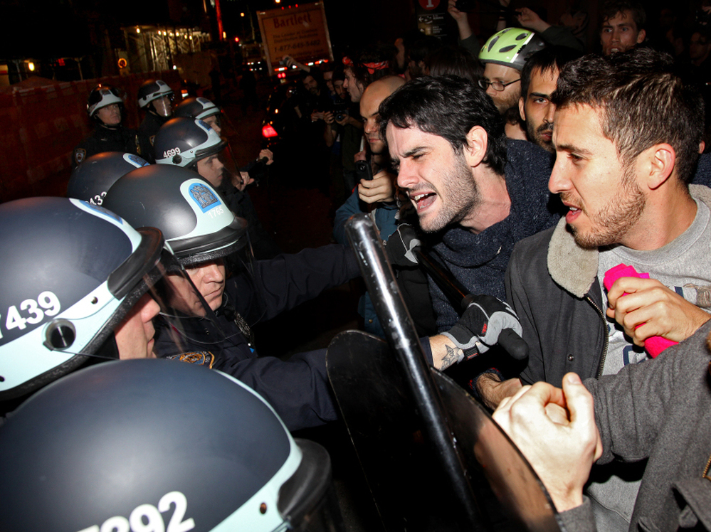Occupy Wall Street protesters clash with police at Manhattan's Zuccotti Park after New York police officers ordered them to leave their longtime encampment.