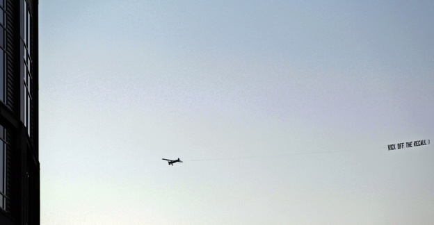 A plane pulls a pro-recall banner near Green Bay, Wis.' Lambeau Field before the Packers-Minnesota Vikings game, Monday, Nov. 14, 2011.