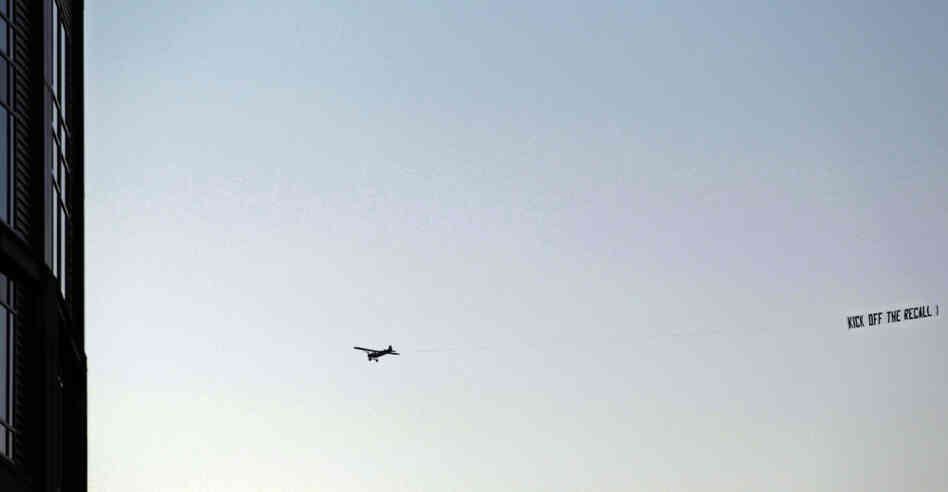 A plane pulls a pro-recall banner near Green Bay, Wis.' Lambeau Field before the Packers-Minnesota Vikings game, Monday, Nov. 14, 2011.
