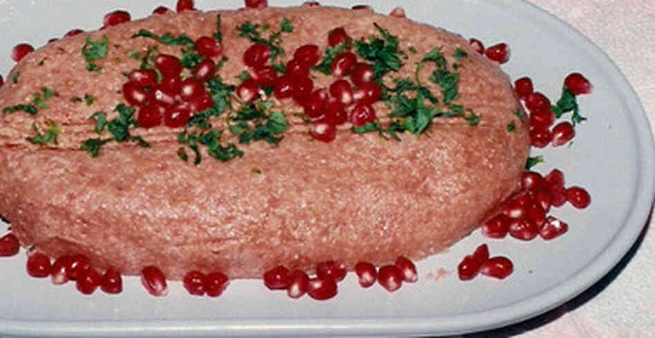 Kibbeh nayeh can be served with fresh herbs and pomegranate seeds (above), or drizzles of olive oil and sliced onion. Kibbeh nayeh can be served with fresh herbs and pomegranate seeds (above), or drizzles of olive oil and sliced onion.