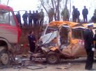 Chinese police stand beside a damaged school bus after it collided with a red truck on a road in the Yulinzi township in northwest China's Gansu province. Chinese police stand beside a damaged school bus after it collided with a red truck on a road in the Yulinzi township in northwest China's Gansu province.