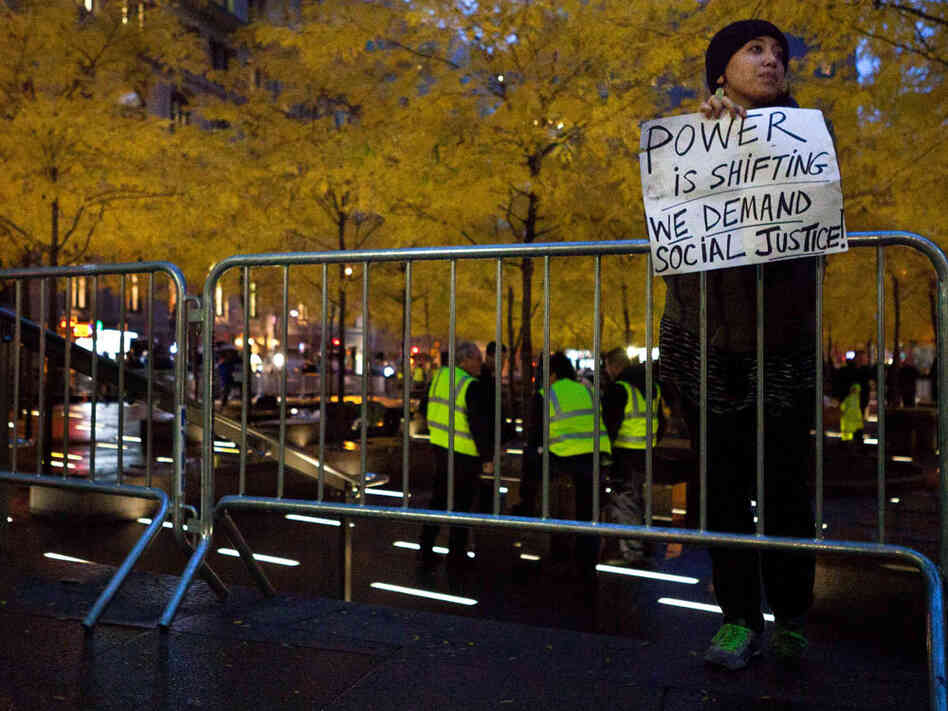 A solitary Occupy Wall Street protestor holds a sign outside a nearly empty Zuccotti Park, Wednesday, Nov. 16, 2011, in New York. A solitary Occupy Wall Street protestor holds a sign outside a nearly empty Zuccotti Park, Wednesday, Nov. 16, 2011, in New York.