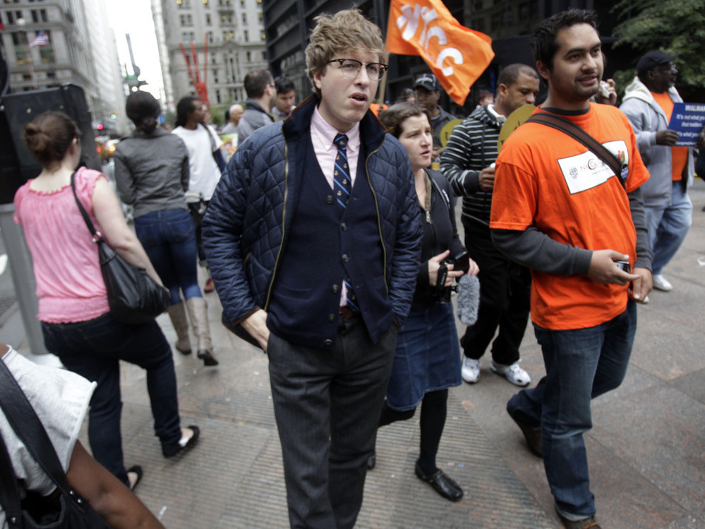 Known online as the "Hipster Cop," Detective Rick Lee (center) walks with protesters in New York in October. The plainclothes officer has been doing community affairs work at the Occupy Wall Street protest.