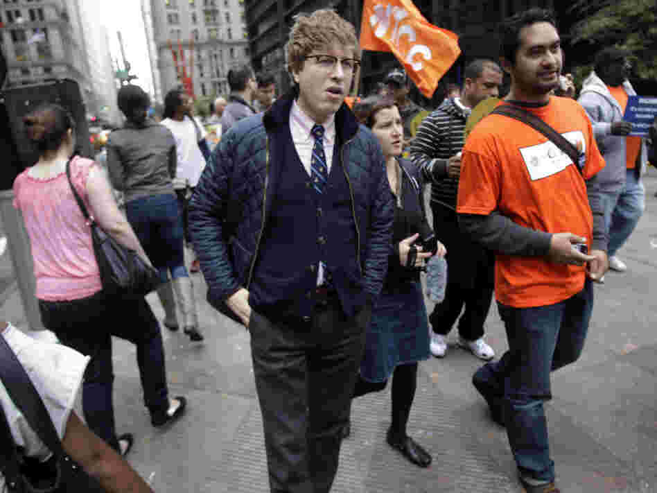 Known online as the "Hipster Cop," Detective Rick Lee (center) walks with protesters in New York in October. The plainclothes officer has been doing community affairs work at the Occupy Wall Street protest.