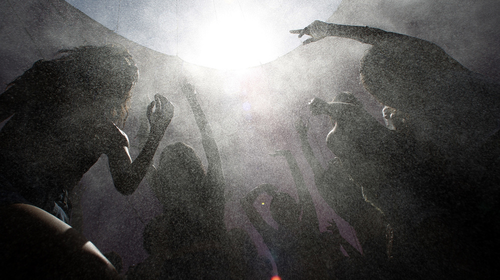 Concertgoers move in a spray of cooling mist as they dance amid the heat of the desert at the hipster Coachella Valley Music & Arts Festival in Indio, Calif., in April. 