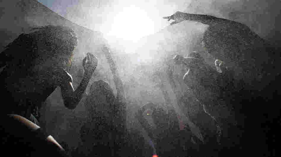 Concertgoers move in a spray of cooling mist as they dance amid the heat of the desert at the hipster Coachella Valley Music & Arts Festival in Indio, Calif., in April. 