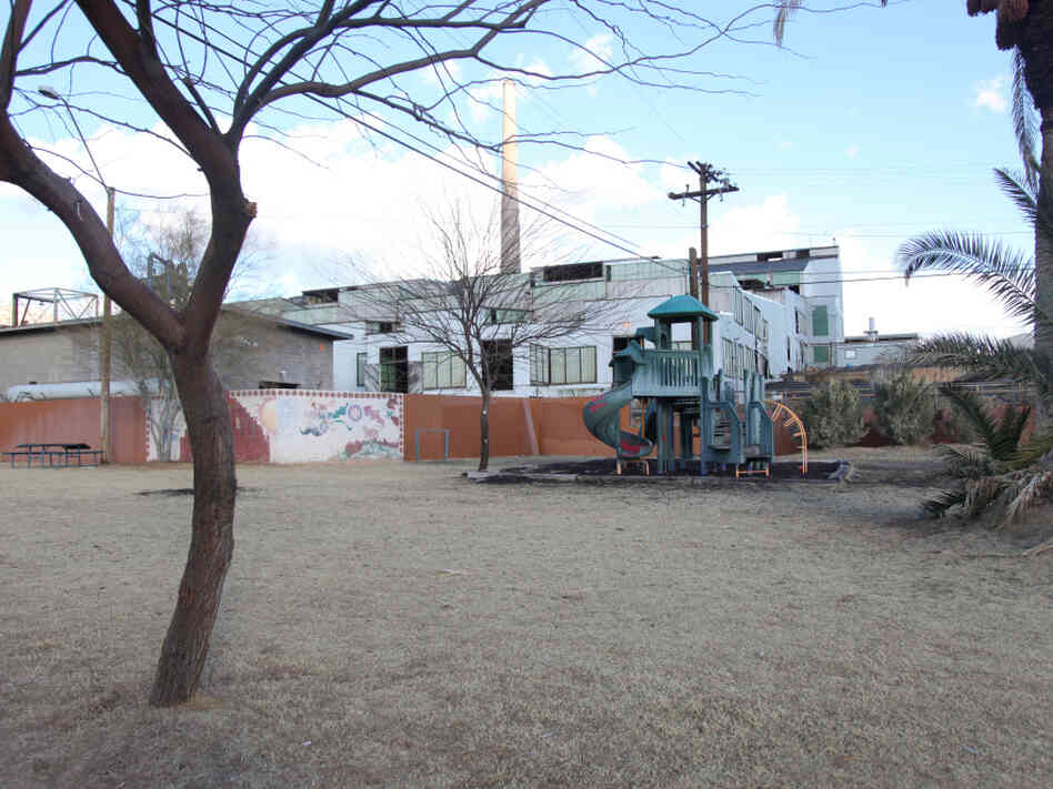 The Asarco copper smelter in Arizona looms behind a playground at the Hayden City Park.