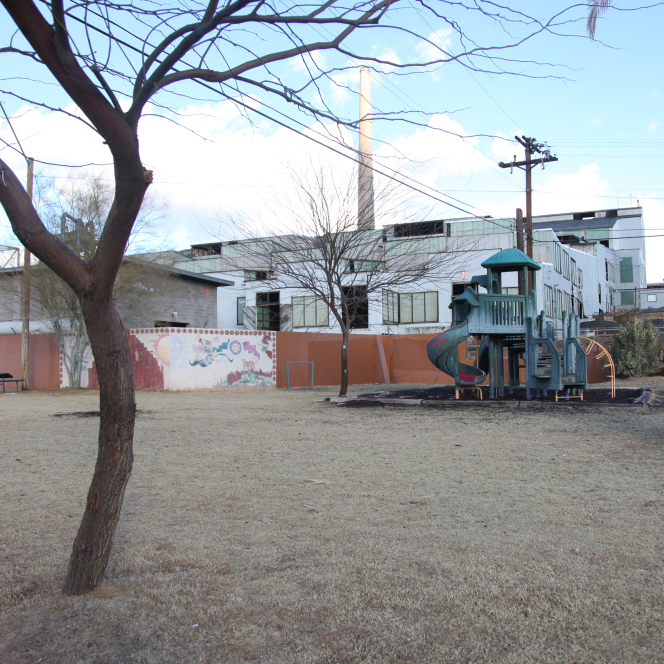 The Asarco copper smelter in Arizona looms behind a playground at the Hayden City Park.