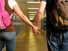Teens hold hand in school Teens hold hand in school