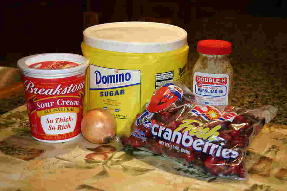 The ingredients: 2 cups whole raw cranberries; 1 small onion; 3/4 cup sour cream; 1/2 cup sugar; 2 tablespoons horseradish from a jar—white or red.